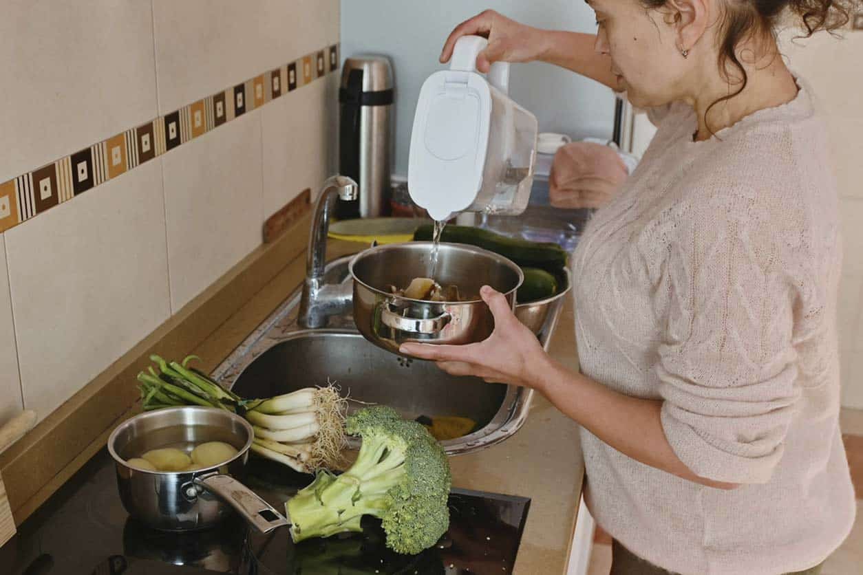 pouring filtered water on veggies